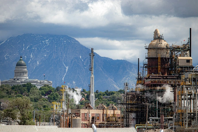 brown and white concrete building near mountain under white clouds during daytime